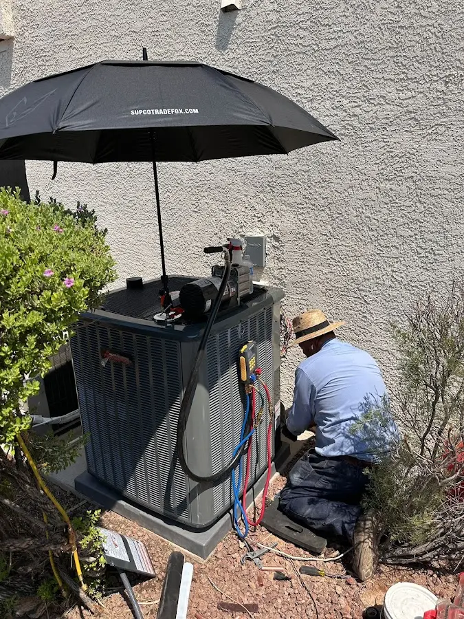 HVAC technician performing outdoor AC maintenance in Scottsburg